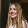 Girl with long blonde hair smiles